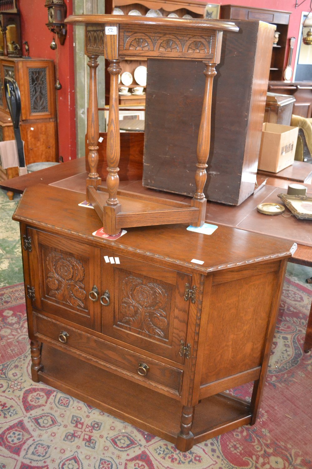 A reproduction oak canted hall cupboard and a D-shaped table, by Jaycee