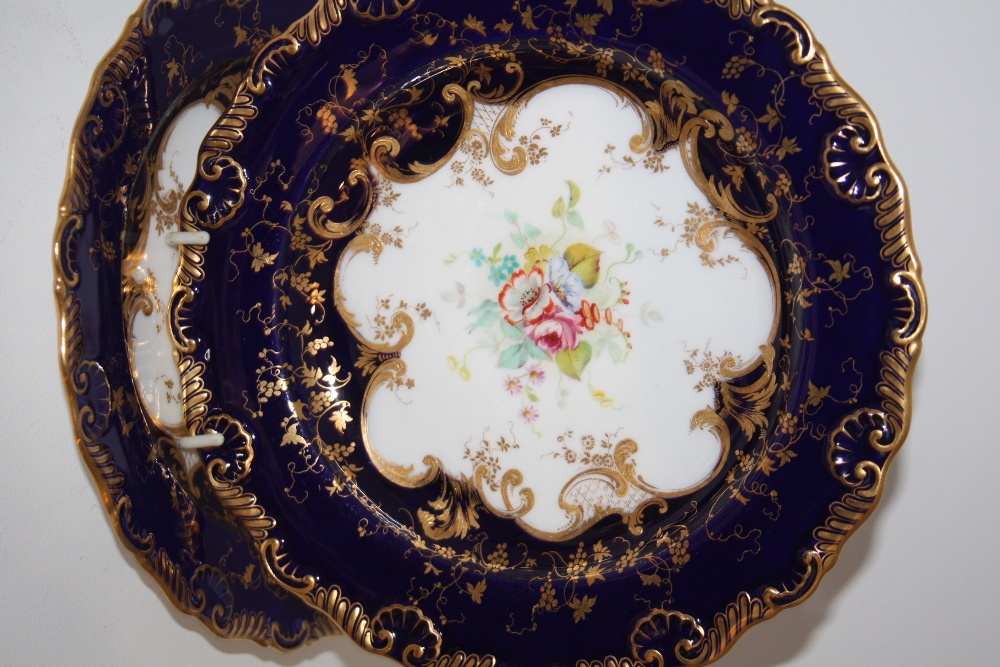 A pair of Royal Worcester cabinet plates, painted to the centre with flowers (2)