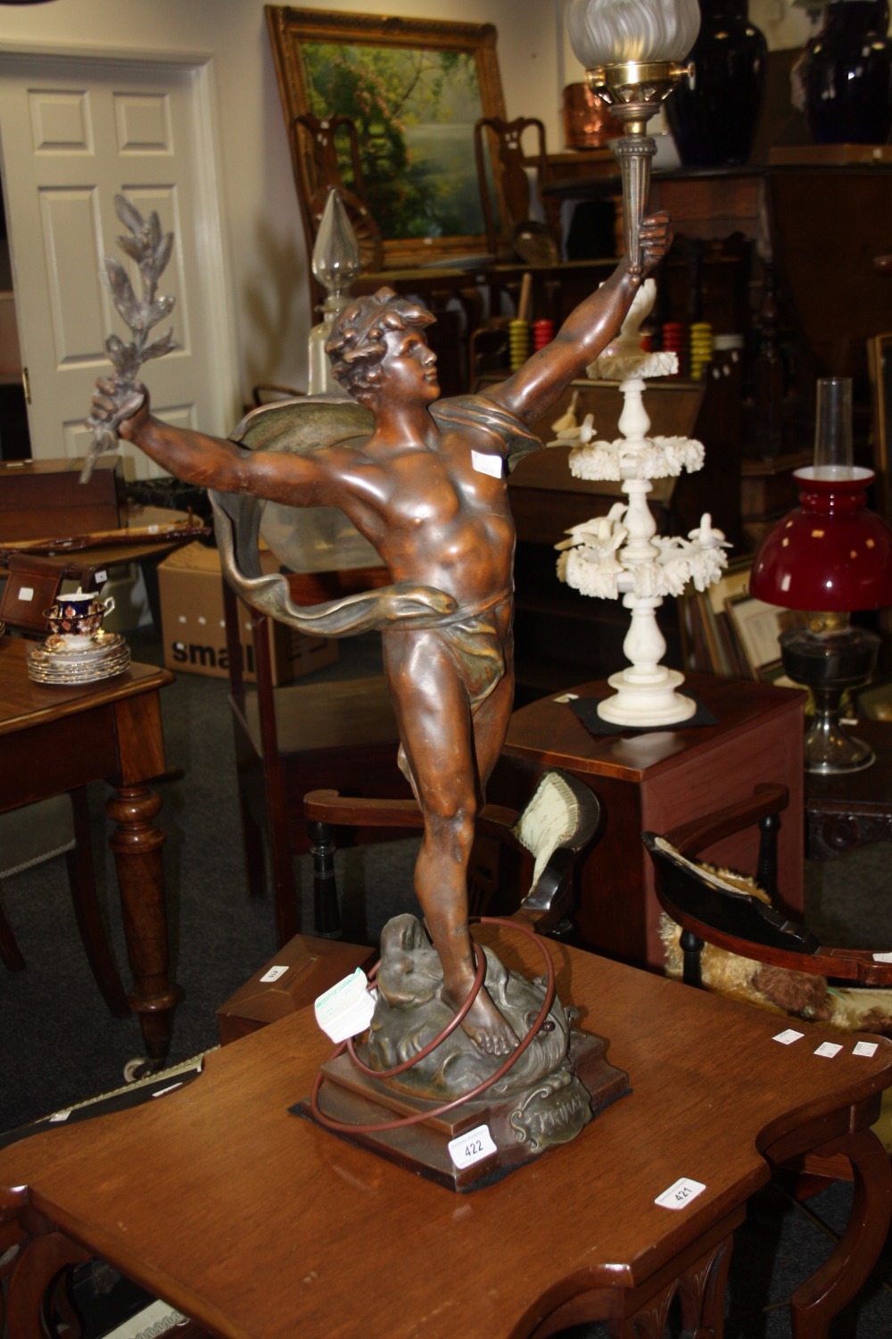 A French bronzed spelter lamp base , modelled as a Grecian god holding a torch