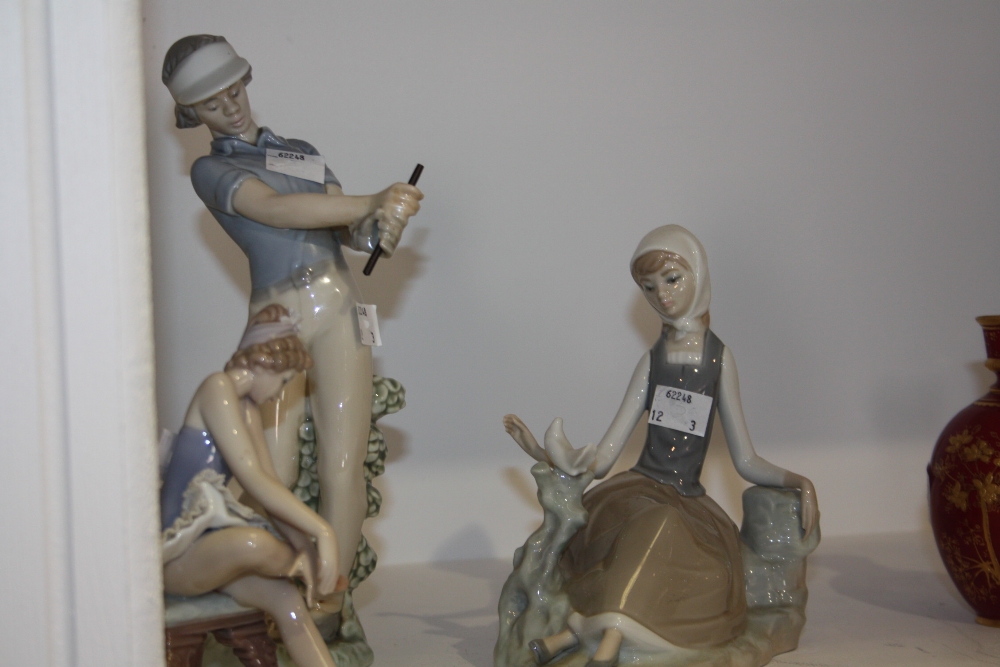 A Nao model, golfing lady; a Lladro ballerina, seated; a Lladro girl, sitting with bird (3)