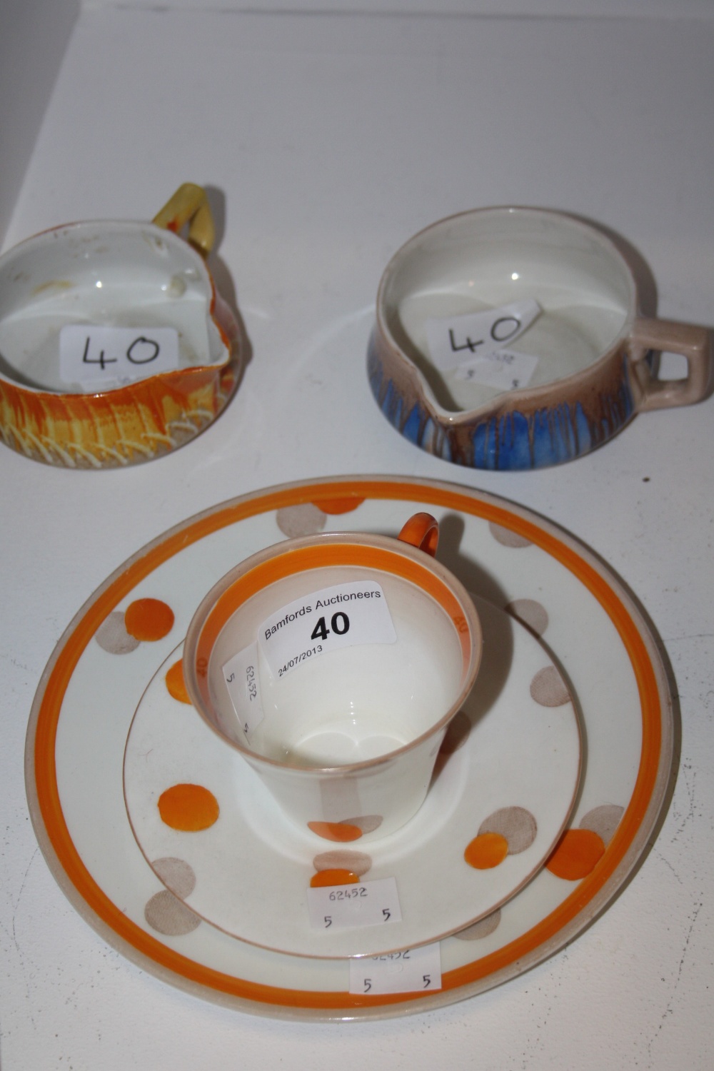 Ceramics- A Shelley orange spot pattern trio set, two Shelley sauce boats