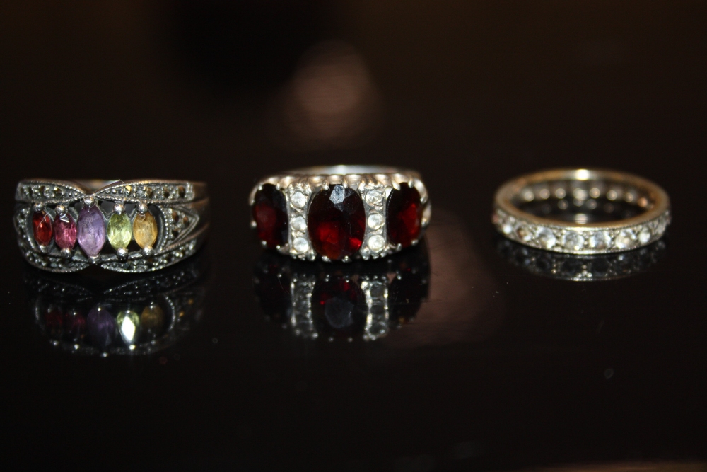 A silver and garnet ring; others, etc (3)