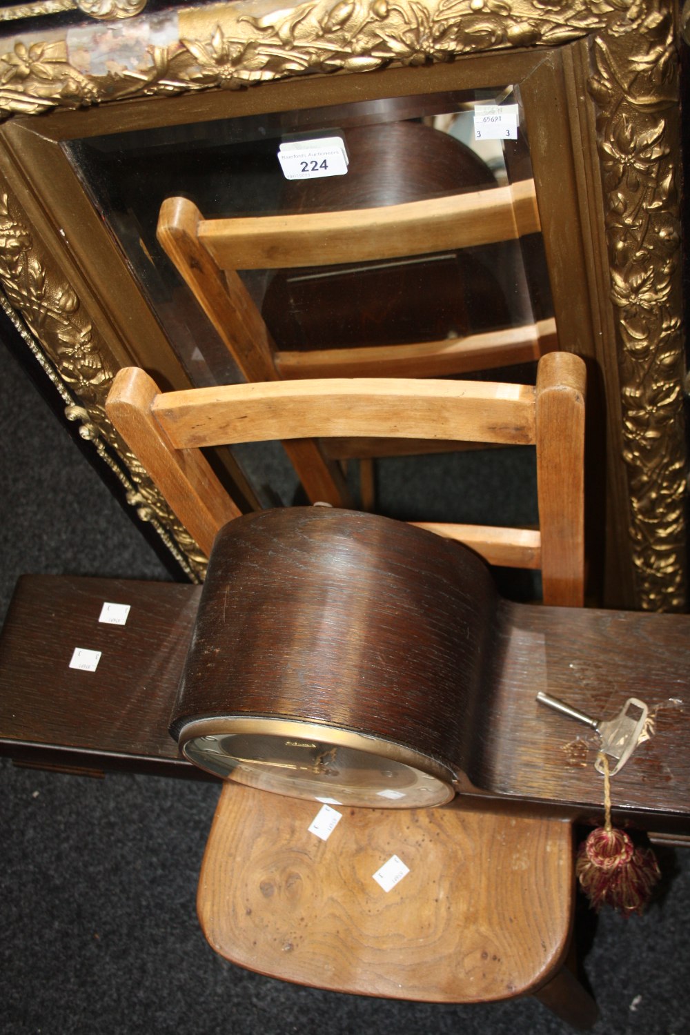 A 1930`s oak mantel clock, three winding holes;  a rectangular mirror;  a child`s beech chair (3)