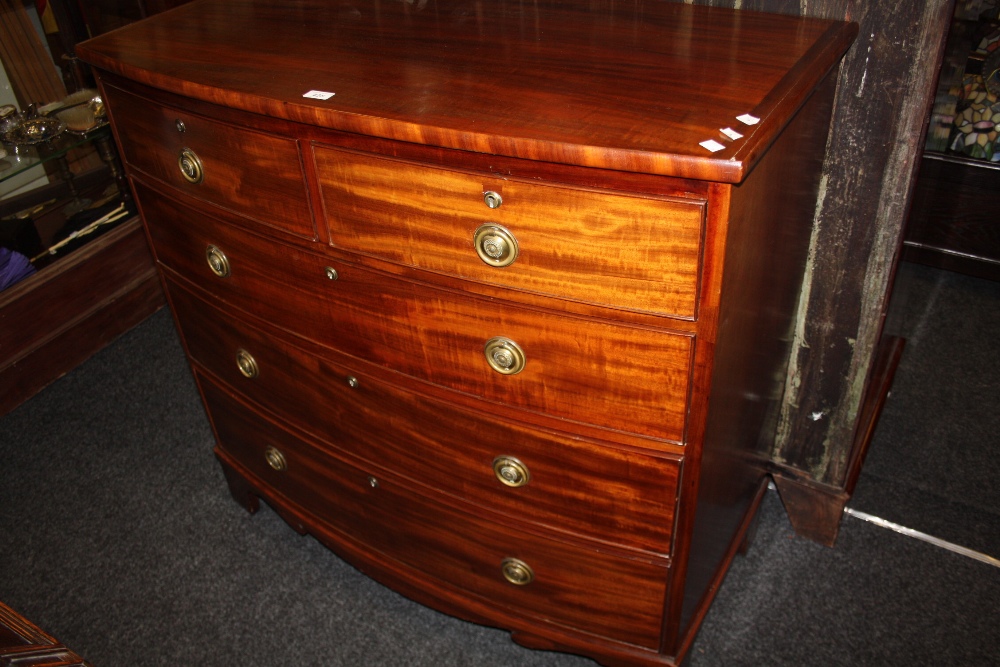 A George III mahogany bow front chest oversailing top, above two short three long graduated cock