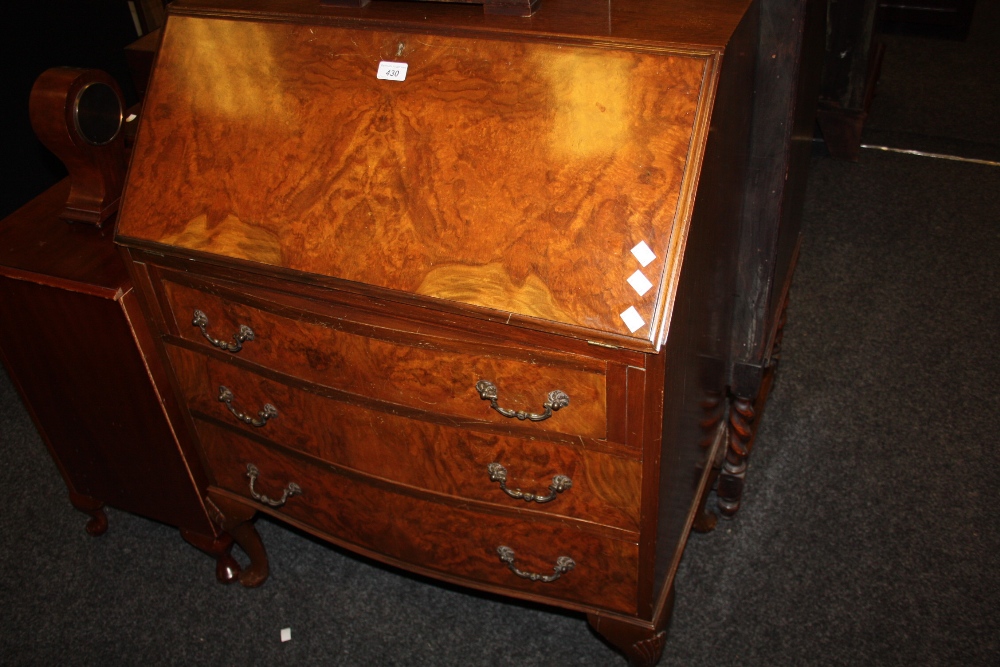 A 1920s burr walnut bureau, with cabriole legs