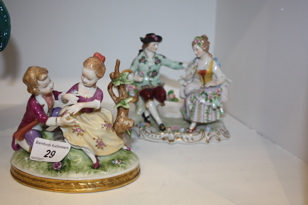 A Dresden figure of a courting couple; another (2)