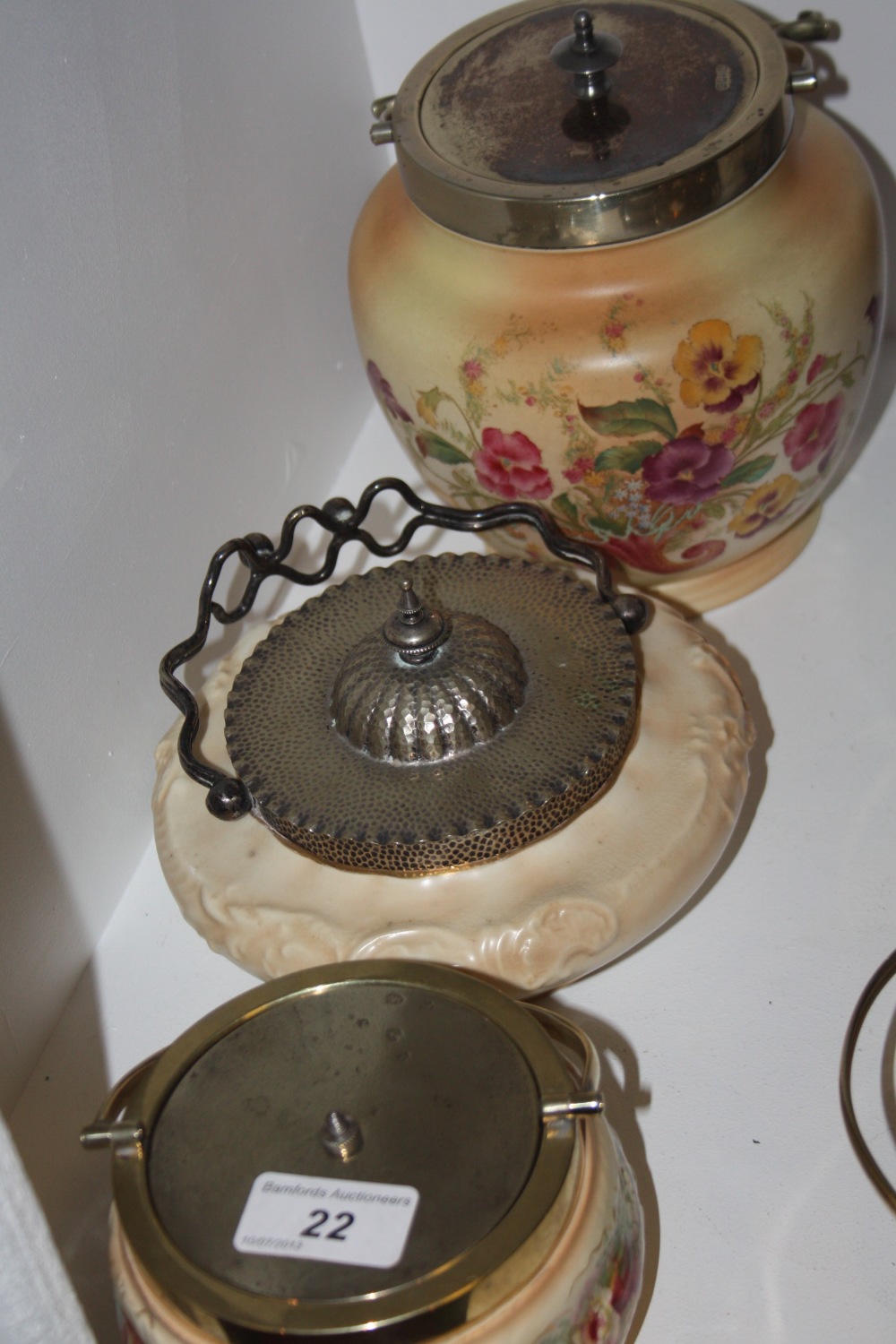 A Carlton ware blush ivory biscuit barrel printed with flowers; a Doulton dish with plated cover;