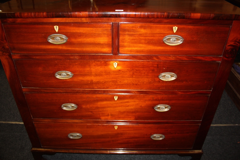 A 19th century mahogany large chest , the oversailling top, above two and three long graduated