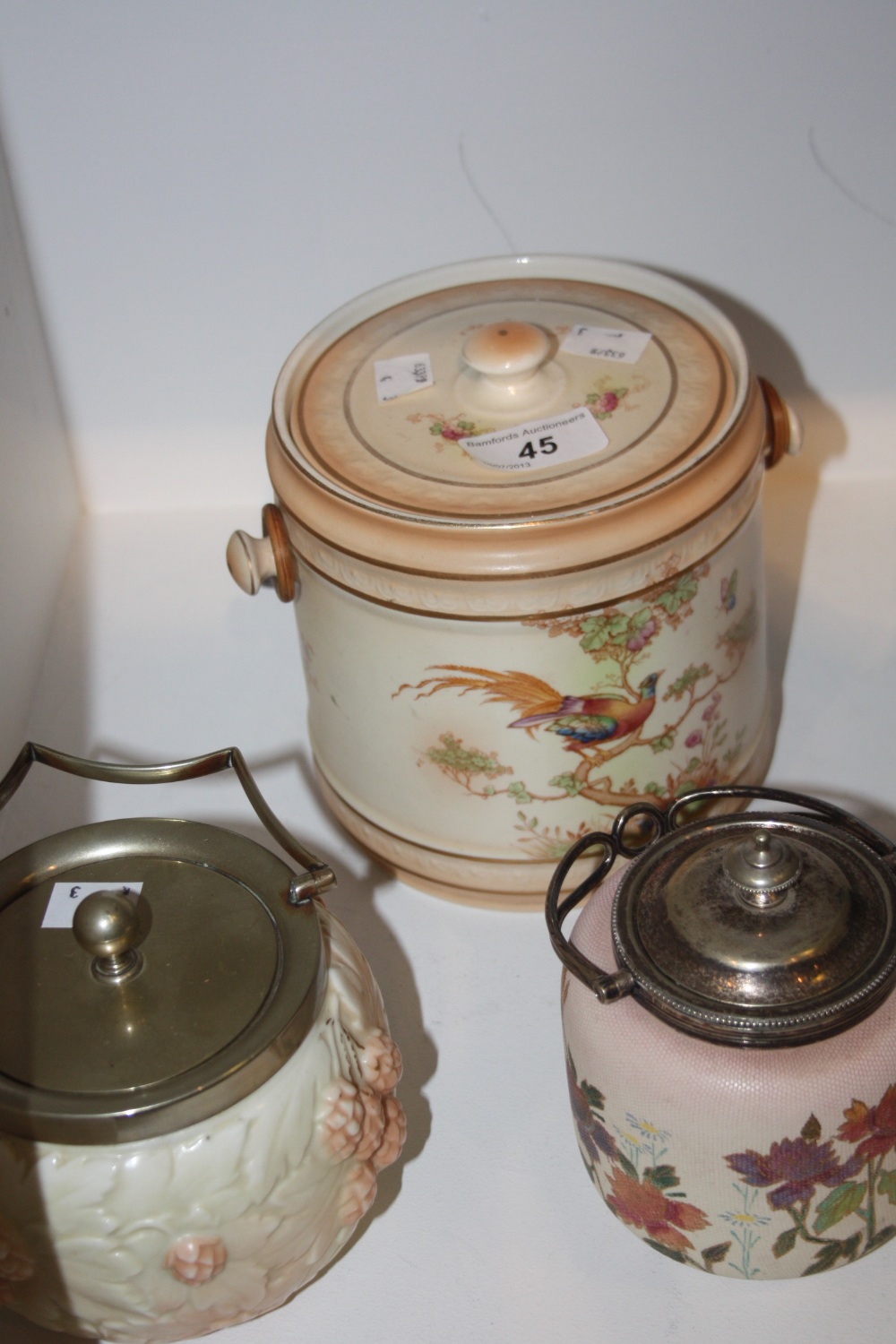 A Crown Ducal blush ivory biscuit barrel painted with  birds and foliage; a Locke & Co blackberry