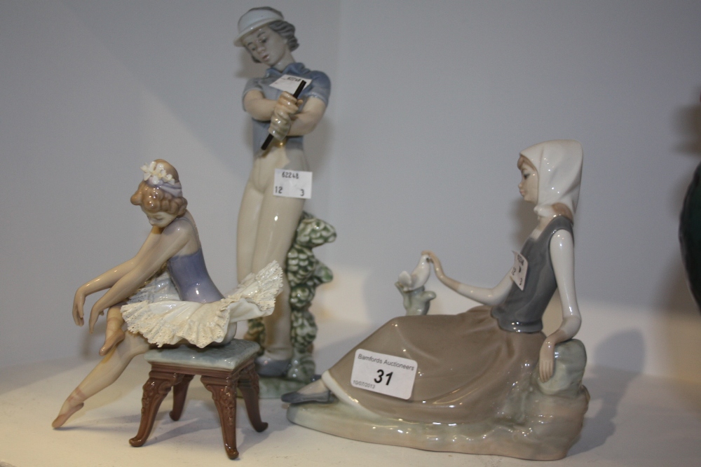 A Nao by Lladro model, golfing lady; a Lladro ballerina, seated; a Lladro girl, sitting with bird (