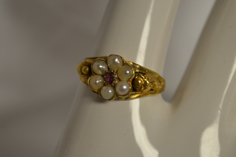 A Victorian garnet, seed pearl and gold coloured metal lady`s ring