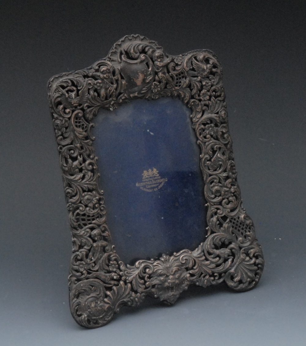 A Victorian shaped rectangular photograph frame, the border pierced and embossed with putti, an owl,