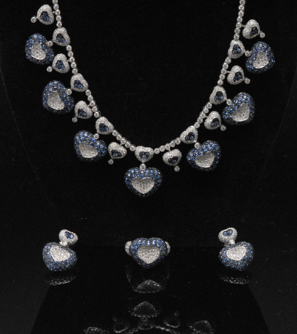 An impressive sapphire and diamond set 18ct gold necklace, with seven sapphire and diamond heart