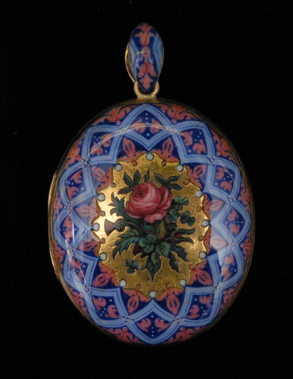A Victorian gold coloured metal locket pendant, well decorated in polychrome enamels with a