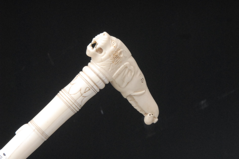A 19th century Anglo-Indian ivory walking cane the L-shaped handle carved with an elephant and a