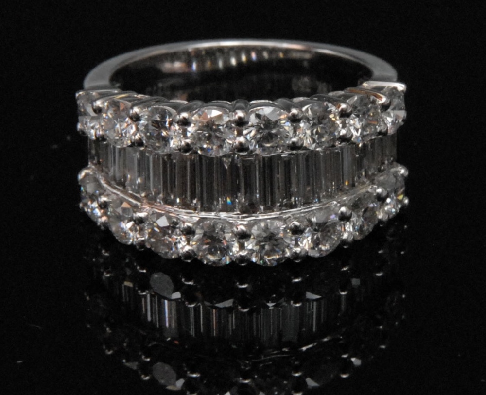 A diamond lady`s ring, set with nineteen baguette cut stones, flanked by two rows of eight brilliant