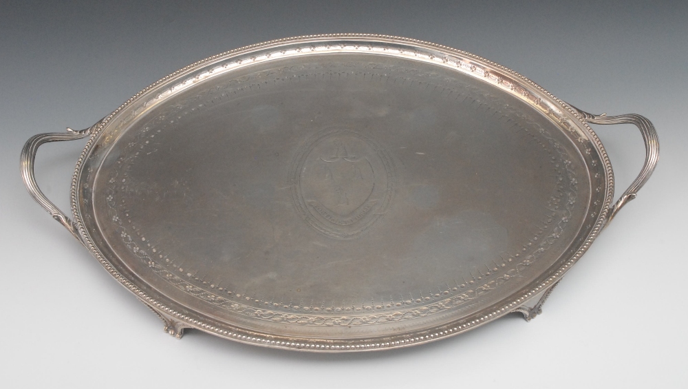 A George III oval  two-handled tray, the field centred with an oval and leopard`s paw erased coat of