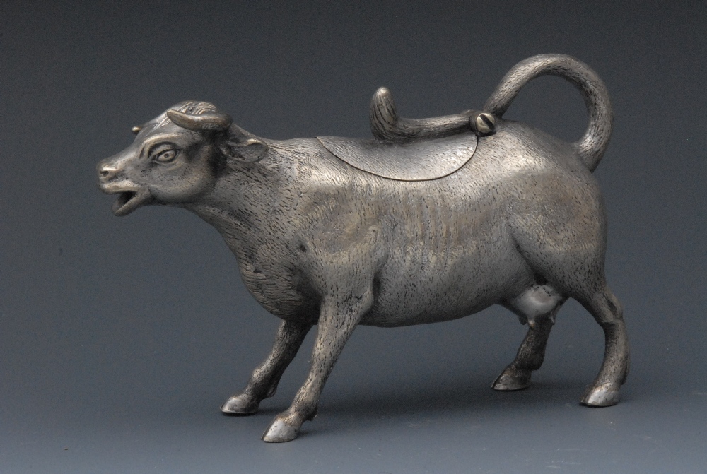 An electro-plated novelty cow creamer, naturalistically cast and chased as a dairy cow, 15cm long,