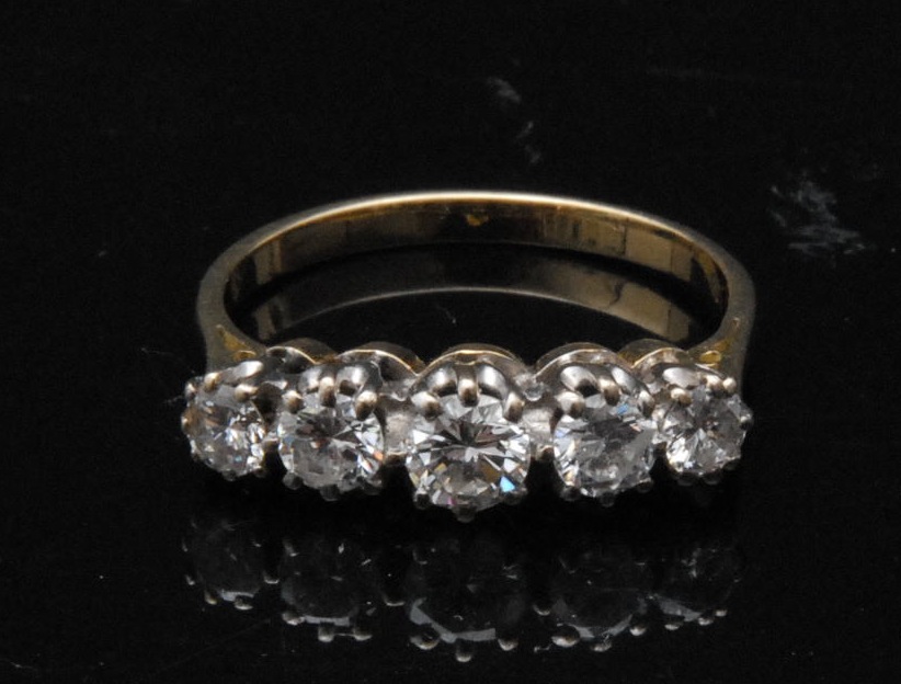 A graduated five-stone diamond ring, yellow metal shank, total carat weight approx 1.7ct,  finger