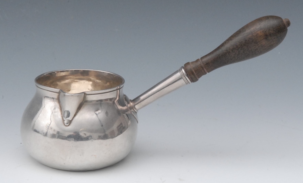 A George III brandy saucepan, turned fruitwood handle, 17cm long, marks worn, London c.1775