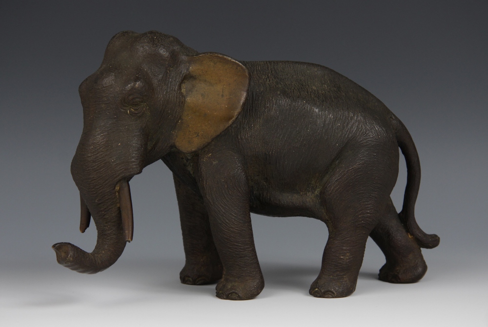 Japanese School (early 20th century), a patinated bronze, of an elephant, standing, 28cm long,