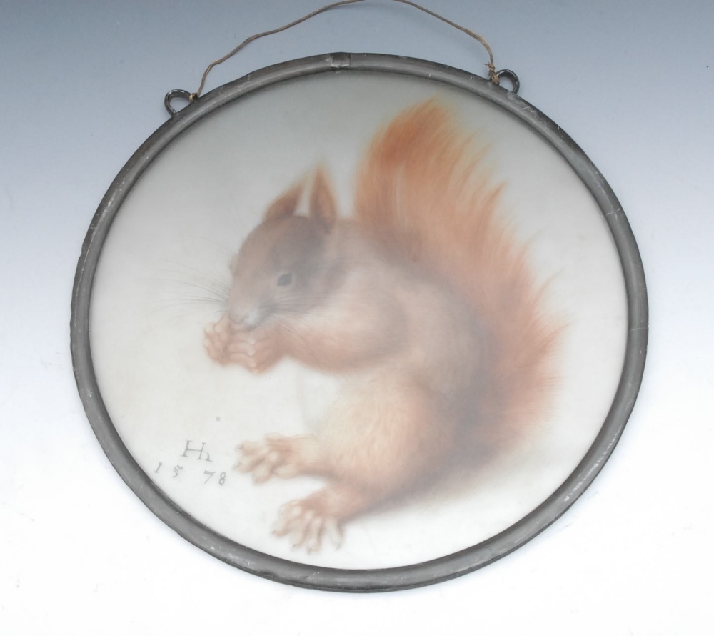 An early 20th century circular lead glass pane, printed with a squirrel and faux dated 1578, 27cm