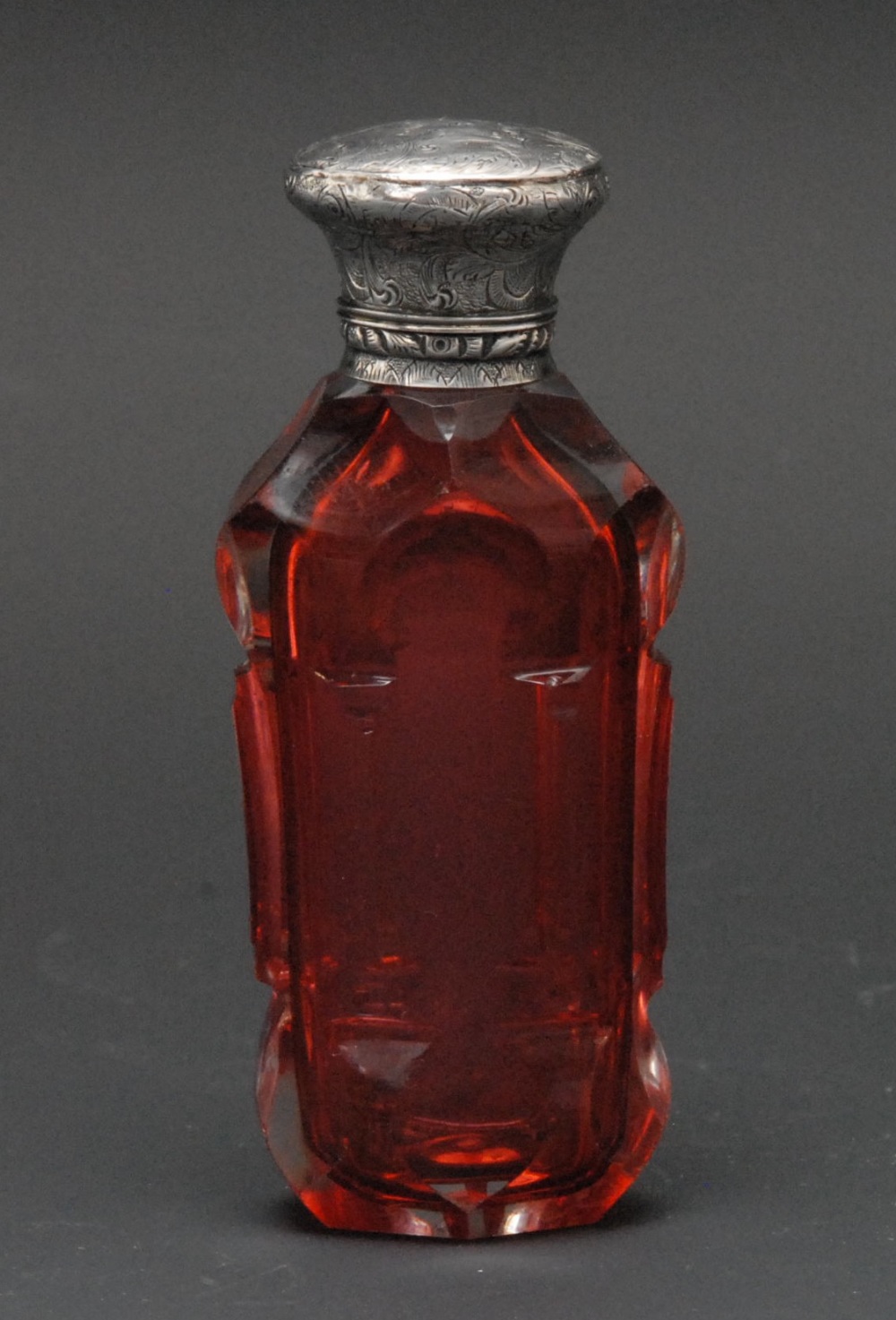 A 19th century silver coloured metal mounted cranberry glass scent bottle, hinged cover engraved