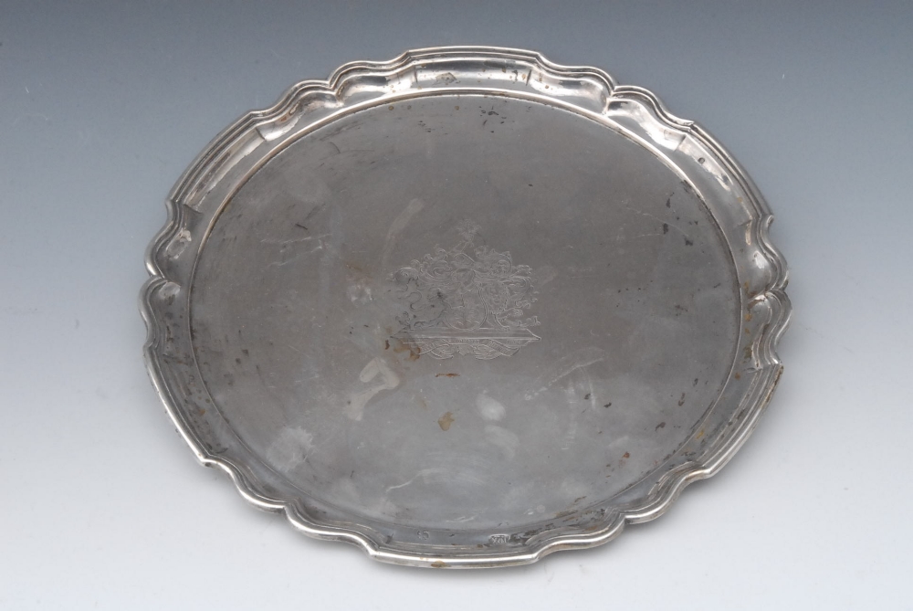 A Continental shaped circular waiter, probably German, piecrust border, the field engraved with