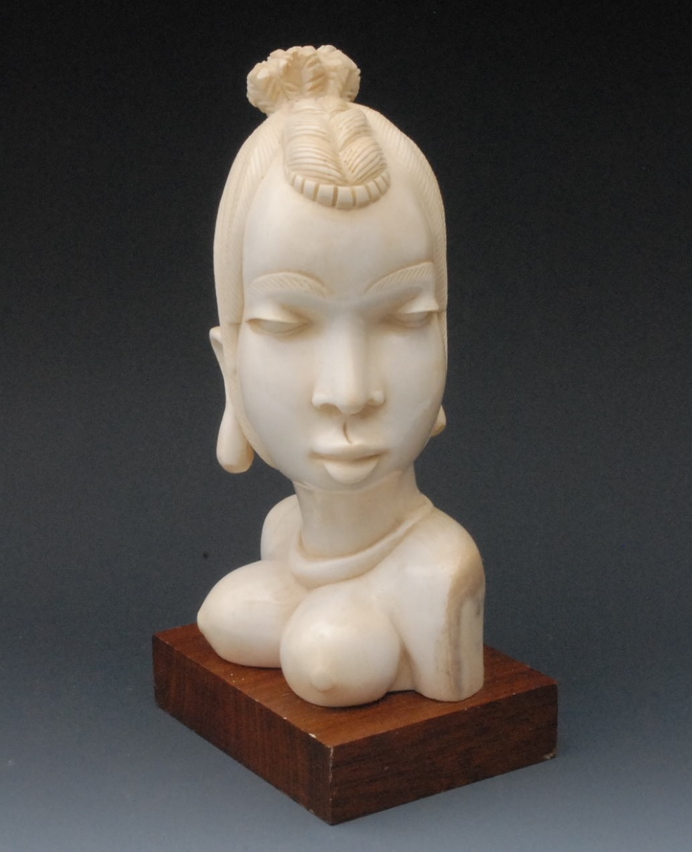 An African ivory carving, of a bare breasted tribeswoman, 24cm high, wooden plinth, c.1930