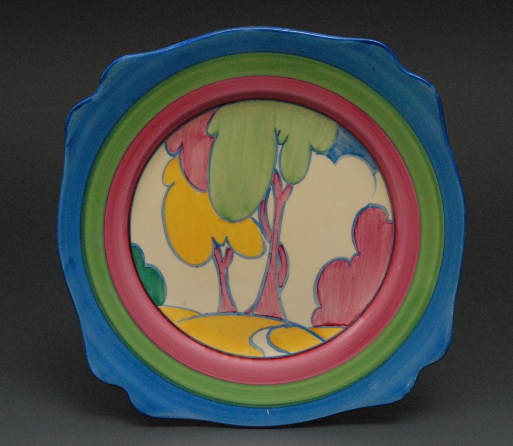 A Clarice Cliff Autumn pattern shaped square plate, brightly decorated with trees, path and