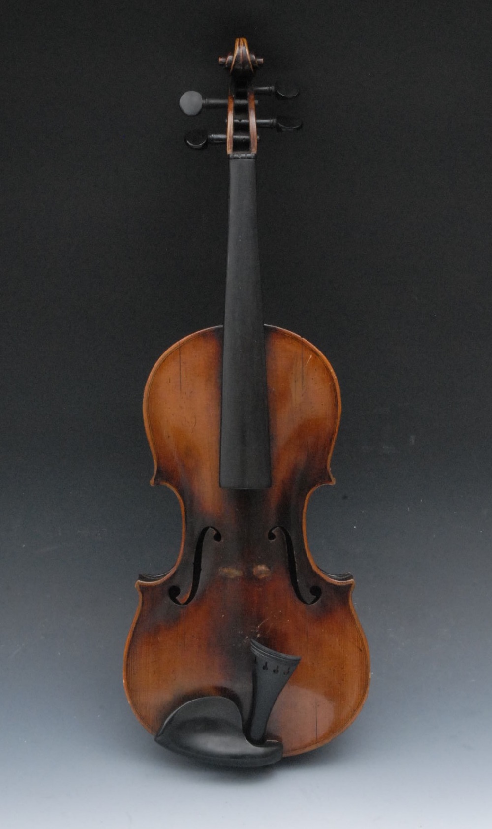 A German violin, the one-piece back 37cm to top of button, ebony tuning pegs and fretboard, outlined