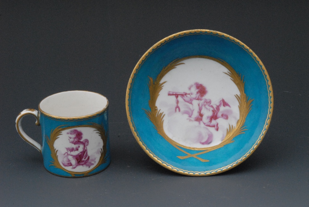 A Chelsea Derby coffee can and saucer,  painted en puce camaieu with Putto on a cloud, raised gilt