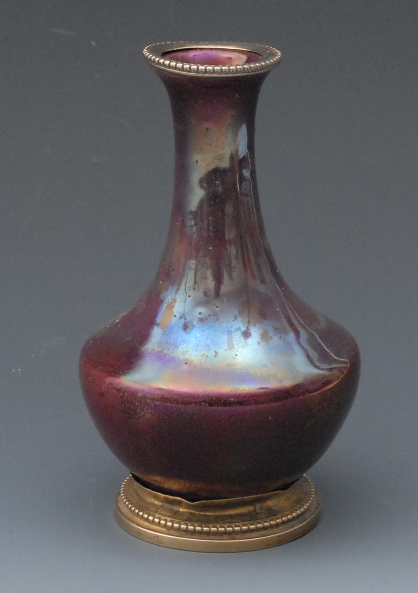 A French Rambervillers ormolu mounted bottle vase, decorated in red metallic glaze, 12.5cm high,