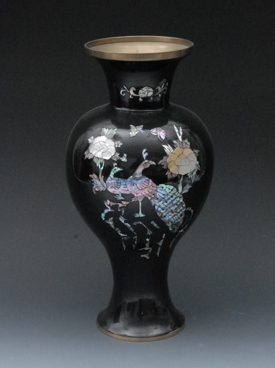 A Japanese `shibayama` baluster vase, decorated with mother-of-pearl raden with peacocks and