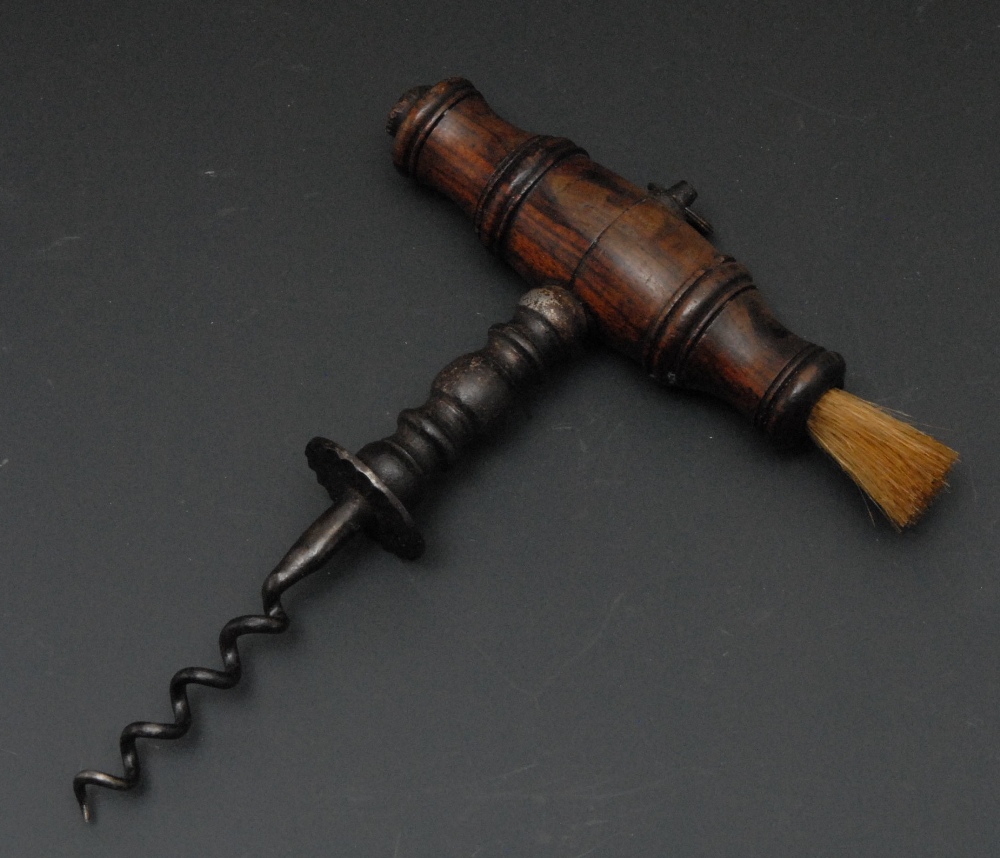 A George III corkscrew, 12.5 steel worm, turned handle with brush, loose ring finial, 15.5cm long,