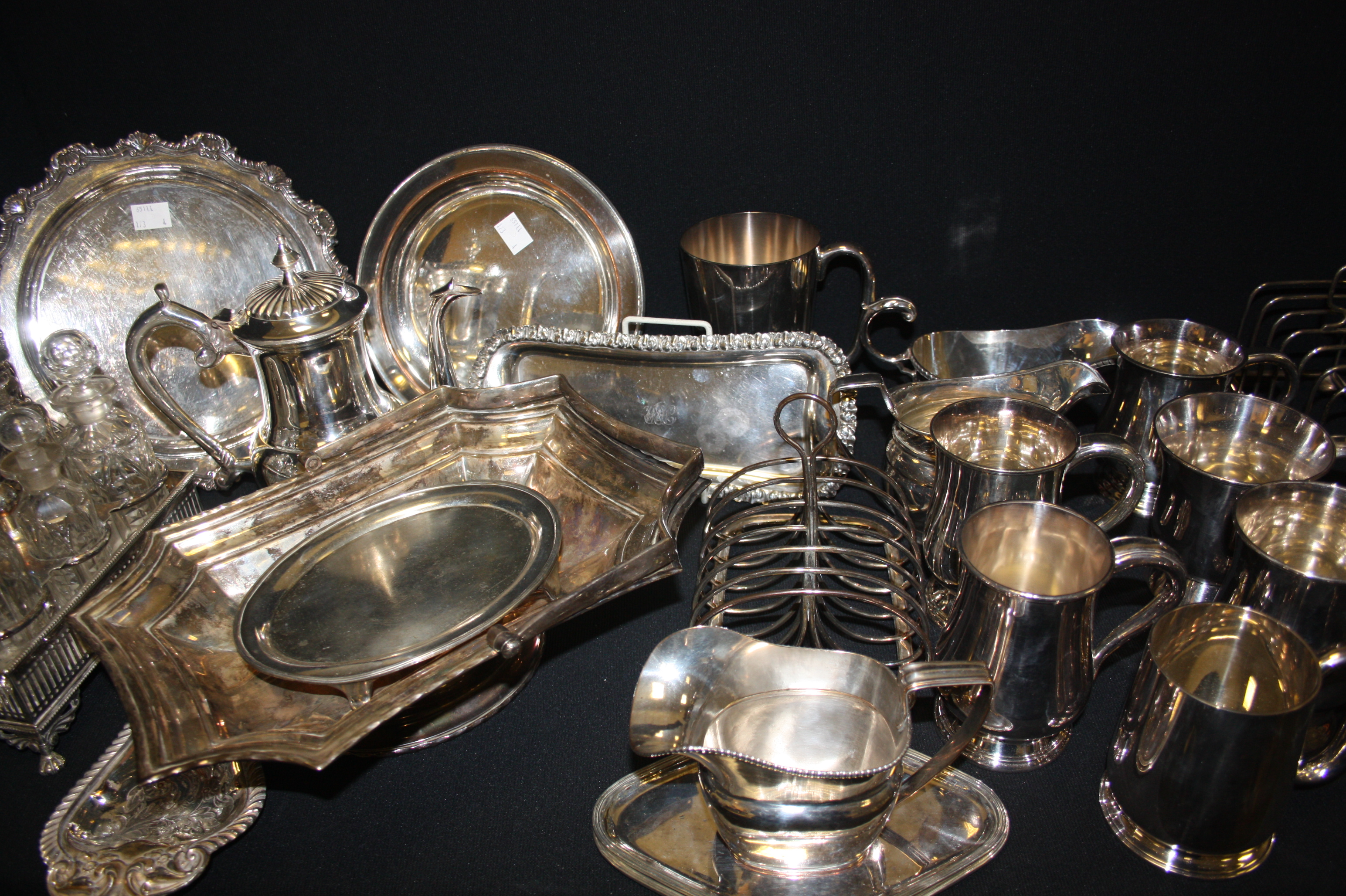 Plated ware- an EPNS six bottle cruet, a George III Sheffield plate cream jug, teapot stand,  etc