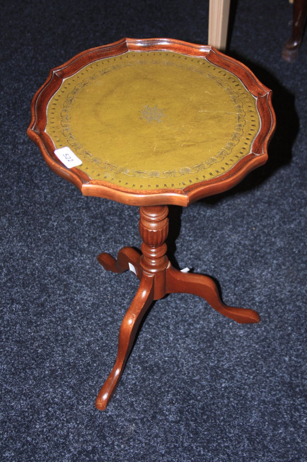 A reproduction tripod wine table