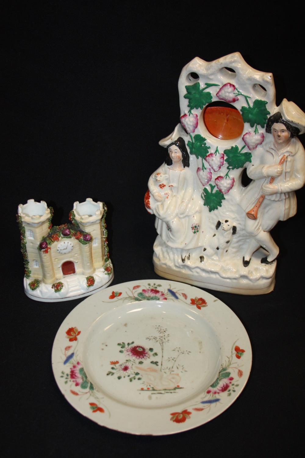 A 19th century Staffordshire pottery watch stand group, c.1880; a spill vase; an 18th century