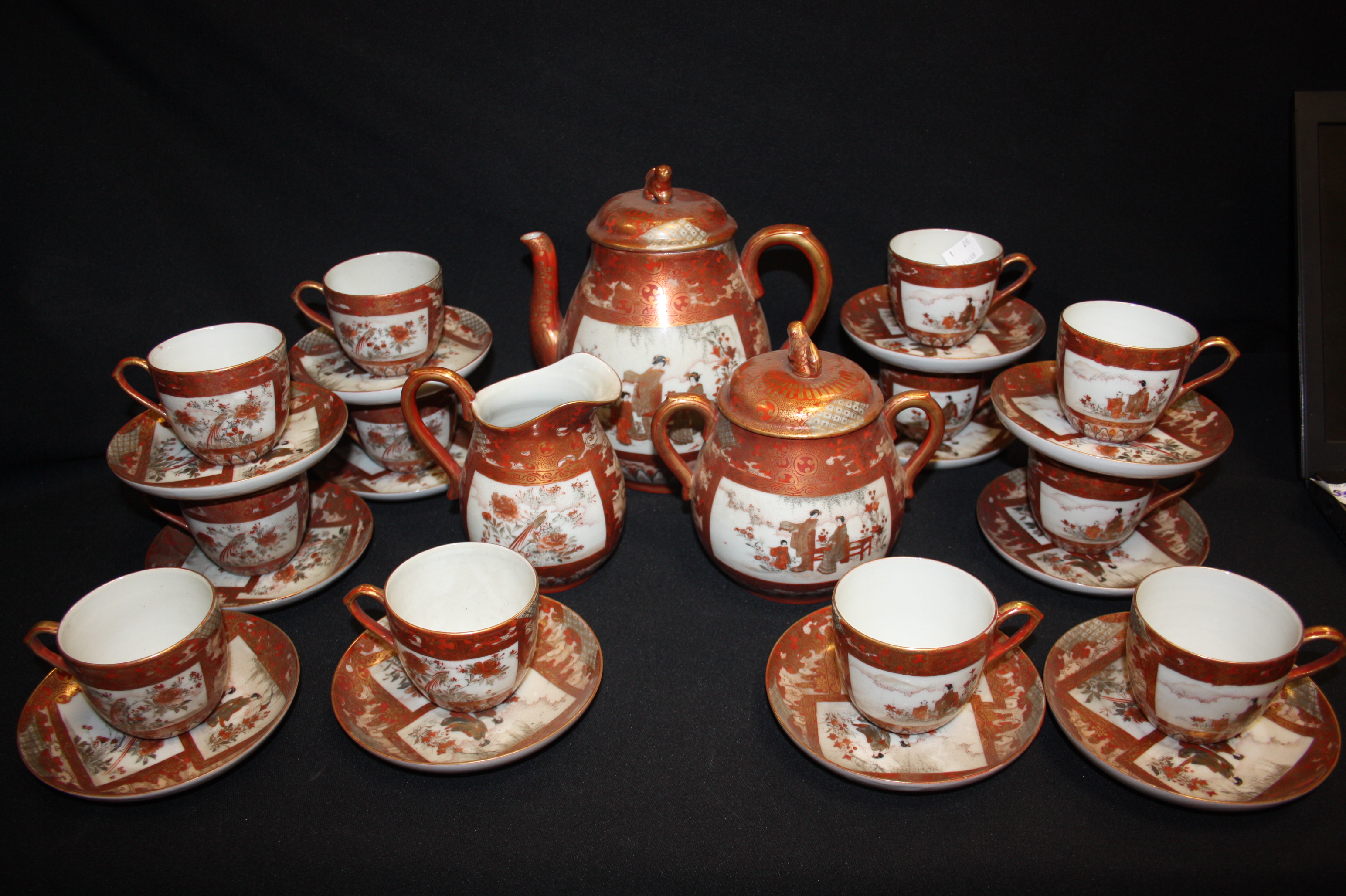 A Japanese satsuma tea set for ten, including milk jug, sucrier, tea pot, etc painted overal with