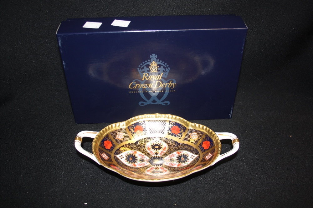 A Royal Crown Derby 1128 full gold two handled navette shaped pedestal dish