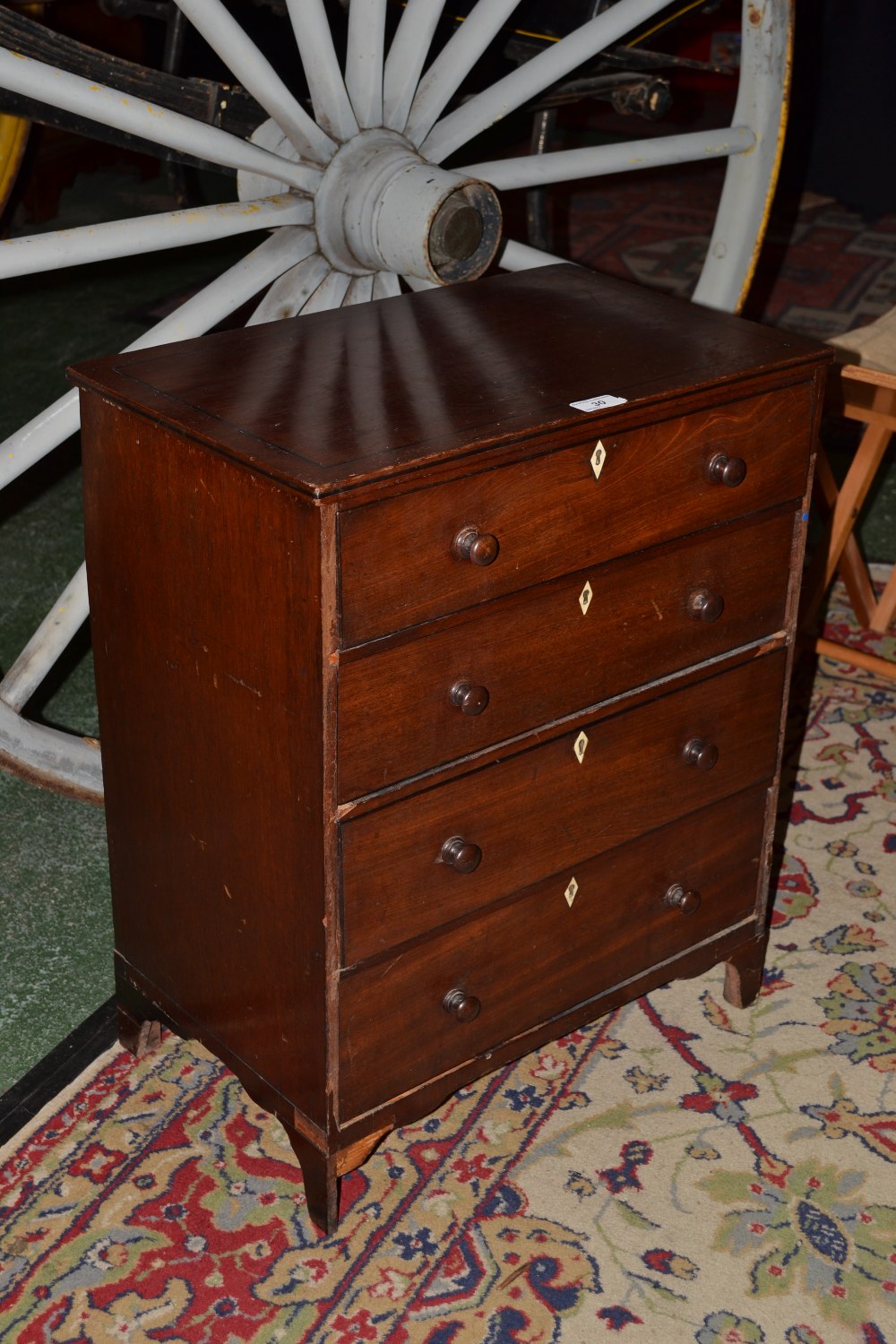 A George III mahogany rectangular chest, top outslined with ebony stringing above four long