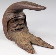 A late 19th Century Continental carved figural table top nutcracker in the form of a bearded man,