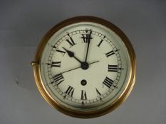 An Astral brass bulkhead clock, enamel dial with Roman numerals and sweep seconds, single barrel