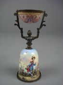 A Continental gilt and enamel wager cup of small size, of traditional female form with polychrome