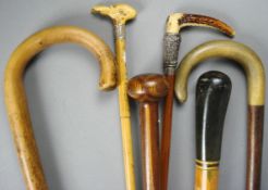 A silver mounted riding crop by Swaine & Co and five various walking sticks.