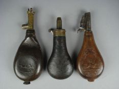 An embossed leather shot flask by G W Hawksly, Sheffield and two leather shot flasks by Dixon &