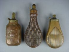 Three late 19th /early 20th century copper and brass powder flasks, one with hunting scene