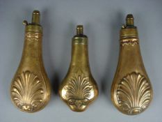 A copper and brass powder flask by G & J W Hawksley with anthemion decoration and two similar