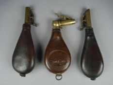 A Dixon & Sons patent brass and leather knuckle spouted shot flask, and two other brass and