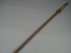 A brass bound iron spear, with geometric decoration and openwork pommel.